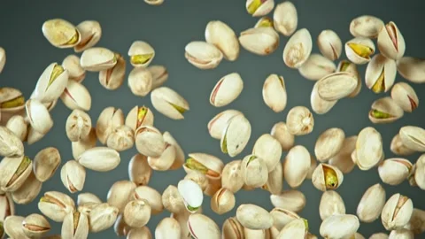 Super Slow Motion Shot of Flying Pistachios After Being Exploded on Grey 스톡 동영상 132456961