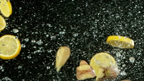 Super Slow Motion Shot of Flying Ginger, and Lemon Collision Stock Footage 149607705