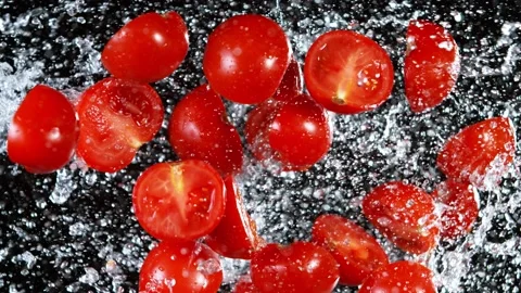 Super Slow Motion Shot of Flying Fresh Tomato Slices and Water Side Splash Stock Footage 157736423
