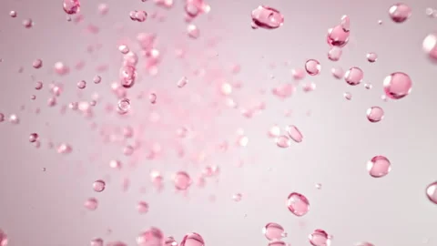 Super Slow Motion Shot of Flying Pink Liquid Drops Towards Camera at 1000fps. Stock Footage 312507886