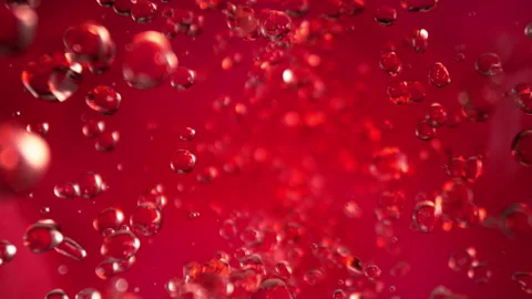Super Slow Motion Shot of Flying Red Lemonade Liquid Drops Towards Camera at Stock Footage 330137844