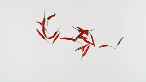 Super Slow Motion Shot of Flying Red Chilli Peppers Isolated on White Background Stock Footage 341236416