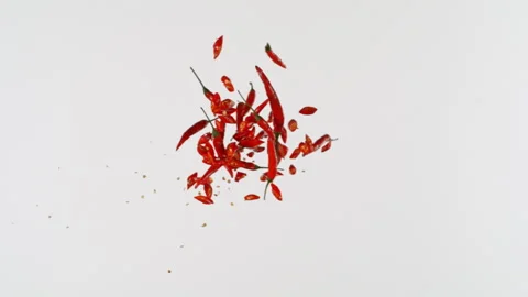 Super Slow Motion Shot of Flying Chilli Peppers Pieces Isolated on White Stock Footage 341833992