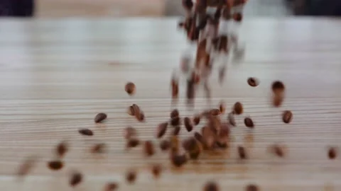Super slow motion shot of fresh roasted brown coffee beans rolling, falling on Stock Footage 138951208