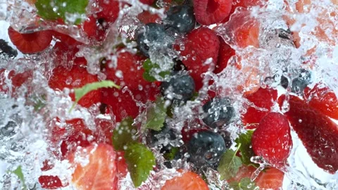 Super Slow Motion Shot of Fresh Berries Falling into Water Whirl at 1000 fps. Stock Footage 243990575