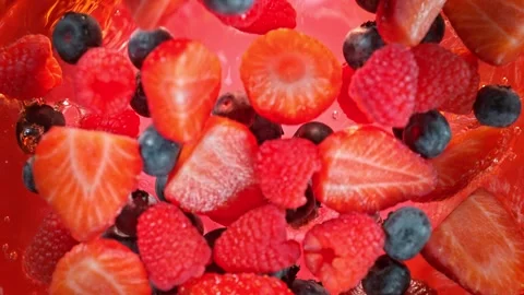 Super Slow Motion Shot of Fresh Berries Falling into Lemonade Whirl at 1000 fps. Stock Footage 244326277