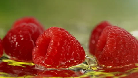 Super Slow Motion Shot of Fresh Raspberries Falling into Water and Making Splash Stock Footage 339444885