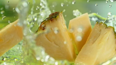 Super Slow Motion Shot of Fresh Pineapple Falling into Water and Making Splash Stock Footage 340462325