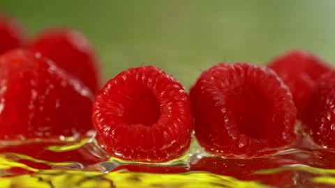Super Slow Motion Shot of Fresh Raspberries Falling into Water and Making Splash Stock Footage 340463047