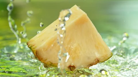 Super Slow Motion Shot of Fresh Pineapple Falling into Water and Making Splash Stock Footage 341293172