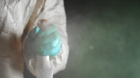 Super Slow Motion Shot of Hand Spraying Disinfection Against the Camera at 1000 128346611