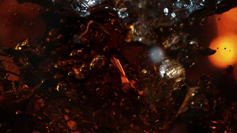 Super Slow Motion Shot of Ice Falling into Fresh Cola Lemonade at 1000fps. Stock Footage 335814537