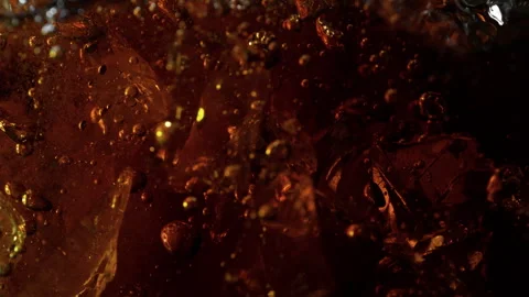 Super Slow Motion Shot of Ice Falling into Fresh Cola Lemonade at 1000fps. Stock Footage 340455345