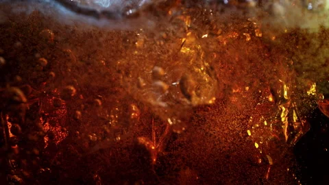 Super Slow Motion Shot of Ice Falling into Fresh Cola Lemonade at 1000fps. Stock Footage 341229140