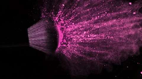 Super Slow Motion Shot of Makeup Brush and Pink Powder Falling on Black Table at Stock Footage 144384749