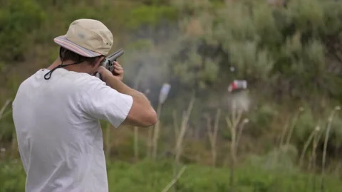 Super slow motion shot of man shooting a shotgun at firing range Stock Footage