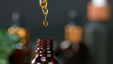 Super Slow Motion Shot of Oily Essence Drop into Phial on Dark Background at Stockbeeldmateriaal 159579901