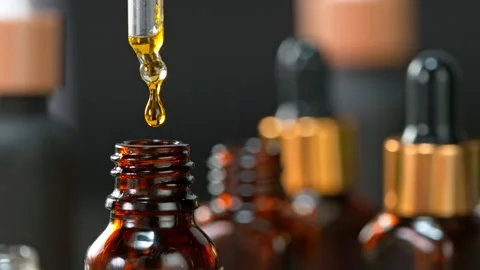 Super Slow Motion Shot of Oily Essence Drop into Phial on Dark Background at Stockbeeldmateriaal 160797050