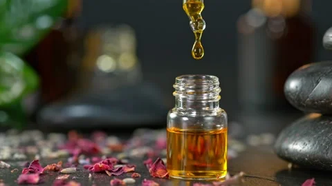 Super Slow Motion Shot of Oily Essence Drop into Phial on Dark Background at Stockbeeldmateriaal 164685041