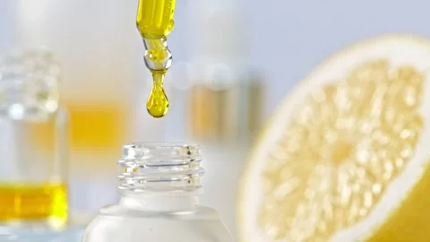 Super Slow Motion Shot of Oily Lemon Essence Drop from Pipette into Phial at Stock Footage 164897318