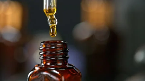Super Slow Motion Shot of Oily Essence Drop into Phial on Dark Background at Stockbeeldmateriaal 171058320