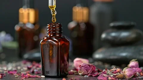 Super Slow Motion Shot of Oily Essence Drop into Phial on Dark Background at Video stock 174649930