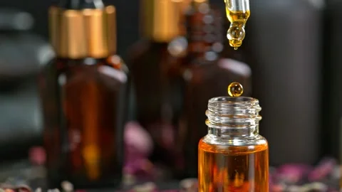 Super Slow Motion Shot of Oily Essence Drop into Phial on Dark Background at Stockbeeldmateriaal 186499741