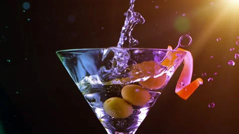 Super Slow motion shot of olive splashing into martini. Stock Footage 133452084