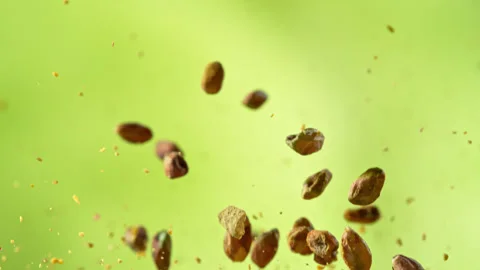 Super Slow Motion Shot of Peeled and Crushed Pistachio Nuts Flying Up at 1000fps Stock Footage 311386491