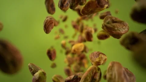 Super Slow Motion Shot of Peeled Pistachio Nuts Falling Around Camera at 1000fps Stock Footage 313189174