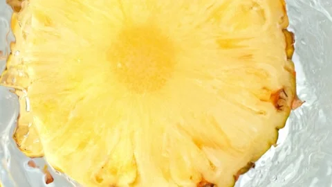 Super Slow Motion Shot of Pineapple Slice Falling Into Water Whirl at 1000 fps. Stock Footage 156352540