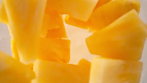 Super Slow Motion Shot of Pineapple Cuts Followed by Camera Falling into Yogurt Video stock 274706370