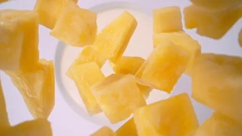 Super Slow Motion Shot of Pineapple Cuts Followed by Camera Falling into Cream Stock Footage 276629419