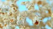 Super Slow Motion Shot Of Popcorn On Blue Background After Being Exploded At Stock Footage
