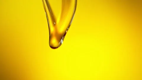 Super Slow Motion Shot of Pouring Golden Oil Liquid at 1000fps. Stock Footage 136781467