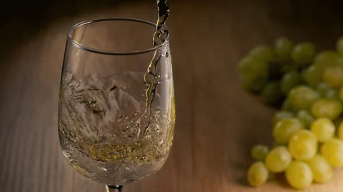 Super Slow Motion Shot of Pouring White Wine on Wooden Background at 1000fps. Stock Footage