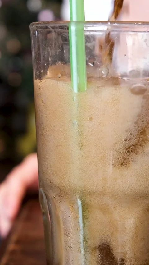 Super Slow Motion Shot of Pouring Fresh Cola Lemonade on Ice Cubes With Camera Video stock 278522743