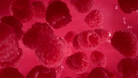 Super Slow Motion Shot of Raspberries Followed by Camera Splashing into Water at Stock Footage 276654578