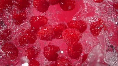 Super Slow Motion Shot of Raspberries Followed by Camera Splashing into Water at Stock Footage 277130045