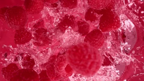 Super Slow Motion Shot of Raspberries Followed by Camera Splashing into Water at Stock Footage 277767122