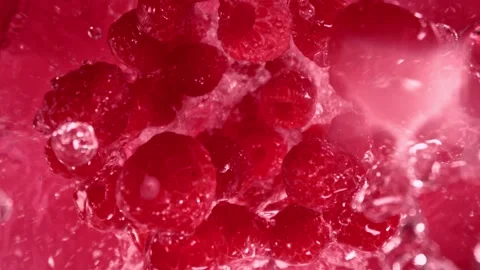 Super Slow Motion Shot of Raspberries Followed by Camera Splashing into Water at Stock Footage 278240335