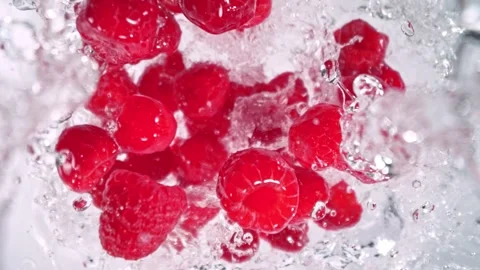 Super Slow Motion Shot of Raspberries Followed by Camera Splashing into Water at Stock Footage 279081117