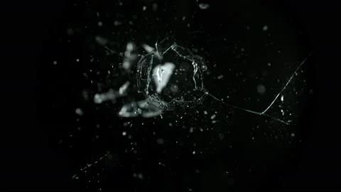 Super Slow Motion Shot of Real Bullet Hole Glass Break Isolated on Black Stock Footage 233388809