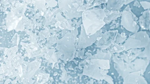 Super Slow Motion Shot of Real Ice Cuts Exploding Towards Camera on Blue Stock Footage 326365097