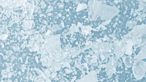 Super Slow Motion Shot of Real Ice Cuts Exploding Towards Camera on Blue Stock Footage 326933764