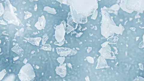 Super Slow Motion Shot of Real Ice Cuts Exploding Towards Camera on Blue Stock Footage 327419987