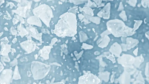 Super Slow Motion Shot of Real Ice Cuts Exploding Towards Camera on Blue Stock Footage 328030675
