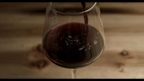 Super Slow Motion Shot of Red Wine Pouring in Glass Stock Footage 270409094