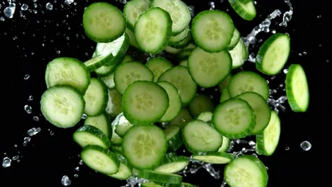 Super slow motion shot of rotating exploded cucumber slices and splashing water Video stock 171567361