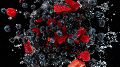Super slow motion shot of rotating exploded berries fruit with splashing water Stock Footage 171643484